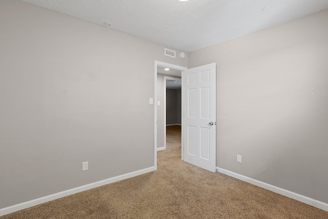 unfurnished room featuring carpet flooring