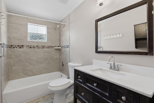 full bathroom featuring vanity, toilet, and tiled shower / bath combo