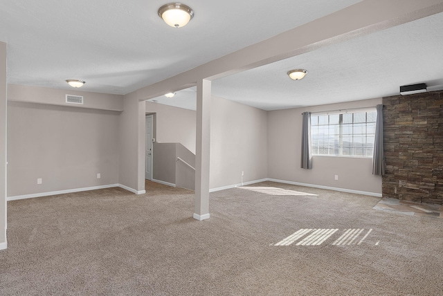 basement featuring carpet and a textured ceiling