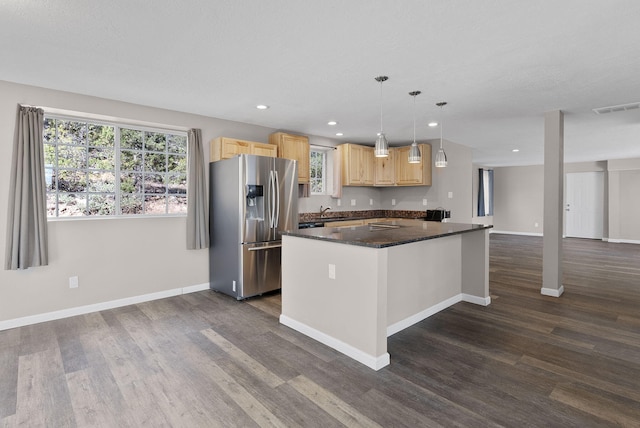 kitchen with light brown cabinets, sink, dark wood-type flooring, stainless steel fridge, and pendant lighting