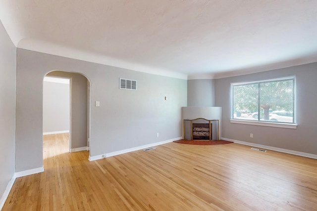 unfurnished living room with light hardwood / wood-style floors and a fireplace