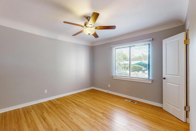 empty room with light hardwood / wood-style flooring and ceiling fan