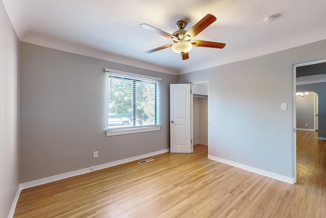 unfurnished bedroom with light hardwood / wood-style floors, a closet, and ceiling fan