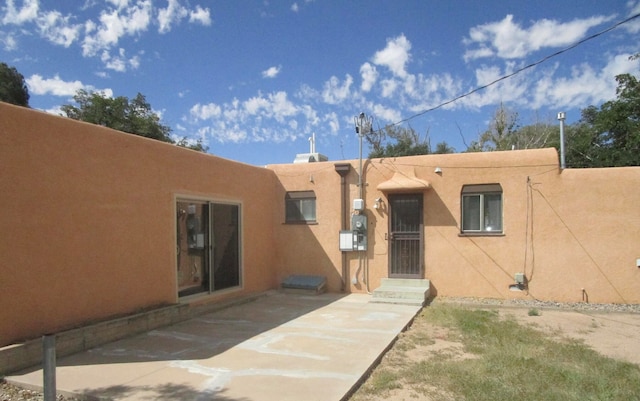 back of house with a patio