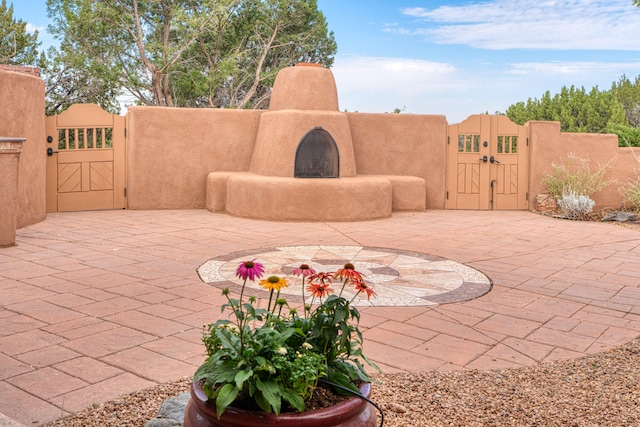 view of patio with an outdoor fireplace