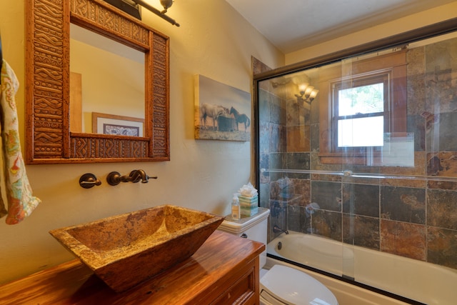 full bathroom with vanity, toilet, and enclosed tub / shower combo