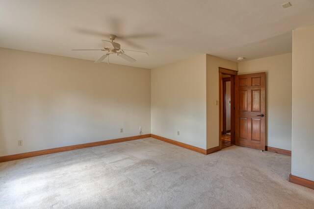 unfurnished room featuring light carpet and ceiling fan