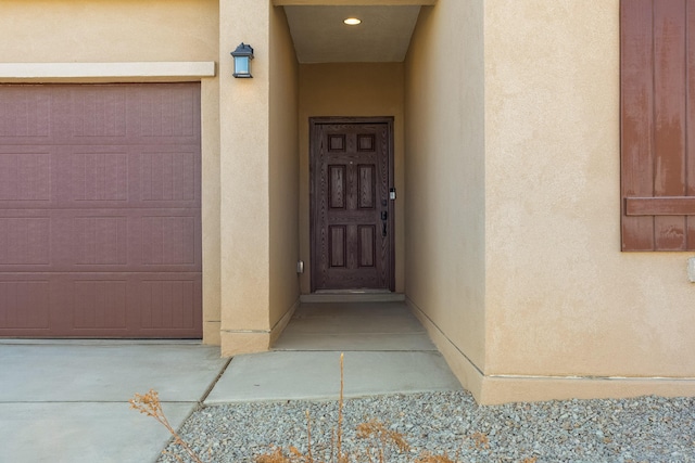 view of exterior entry featuring a garage