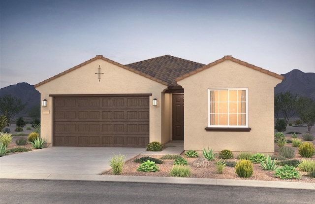 view of front facade with a mountain view and a garage