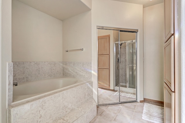 bathroom featuring plus walk in shower and tile patterned flooring