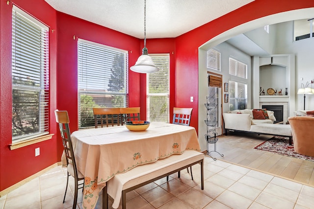 dining space with light hardwood / wood-style floors and a textured ceiling