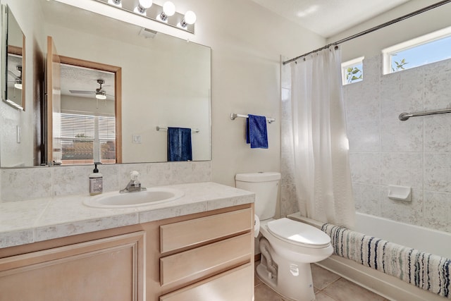 full bathroom with tile patterned floors, shower / bath combo, toilet, vanity, and ceiling fan