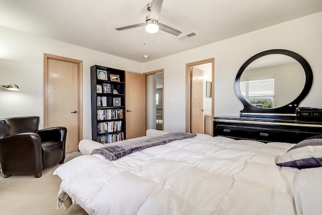 bedroom featuring connected bathroom, carpet flooring, and ceiling fan