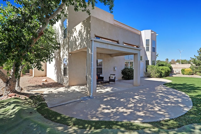 back of house with a patio