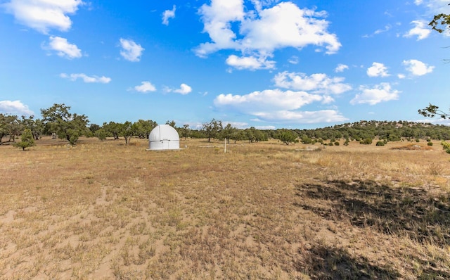 view of yard with a rural view