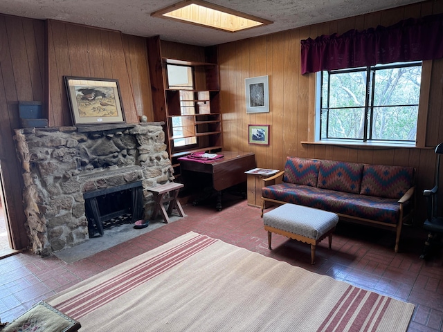 kitchen with stove, a stone fireplace, and light tile patterned floors