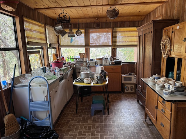 kitchen with blue cabinetry, sink, ceiling fan, and light tile patterned floors