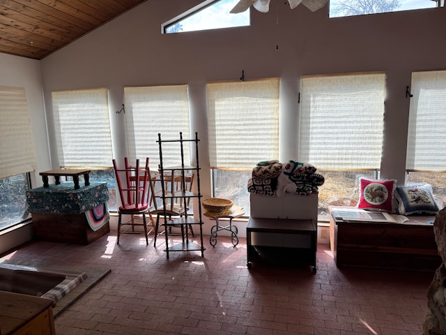 sunroom with a wealth of natural light, vaulted ceiling, wooden ceiling, and ceiling fan