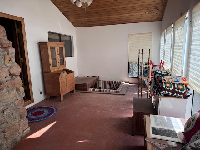 interior space featuring wood ceiling, a healthy amount of sunlight, ceiling fan, and vaulted ceiling