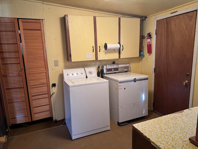 laundry room with washing machine and dryer and cabinets