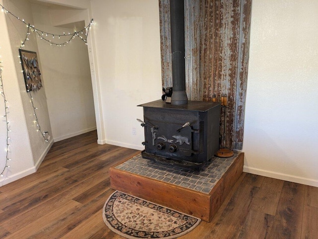 interior details featuring hardwood / wood-style flooring and a wood stove