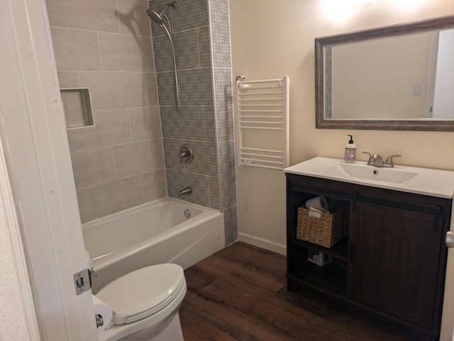 full bathroom featuring vanity, toilet, tiled shower / bath combo, and hardwood / wood-style floors