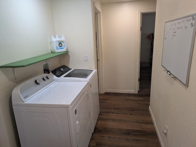 laundry area featuring washer and dryer and dark hardwood / wood-style flooring