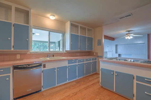 kitchen with sink, dishwasher, white gas cooktop, tile counters, and light hardwood / wood-style flooring