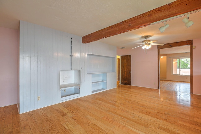 bathroom with a tile shower, toilet, tile walls, and sink