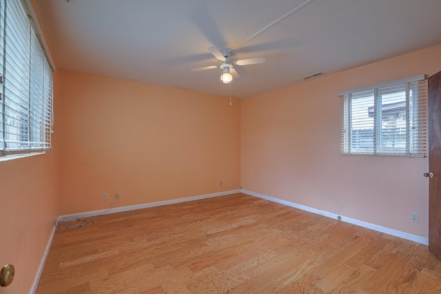 unfurnished room with ceiling fan and light wood-type flooring