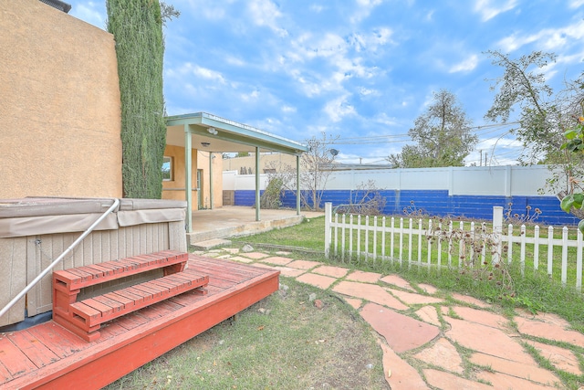 view of yard featuring a hot tub, a patio area, and a deck