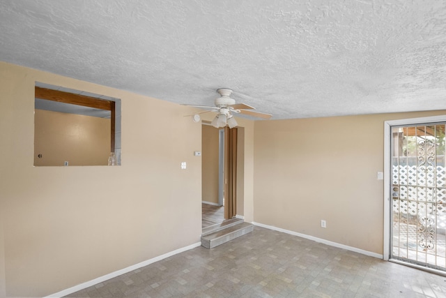 unfurnished room with a textured ceiling and ceiling fan