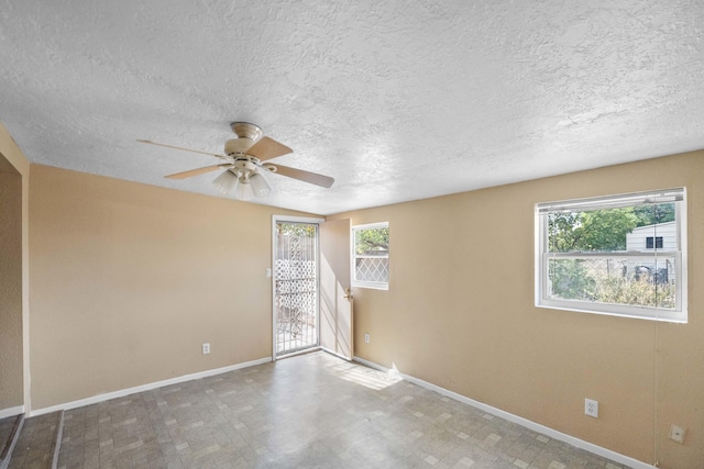 empty room featuring a textured ceiling and ceiling fan