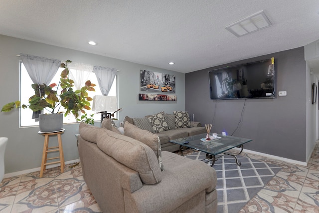 living room featuring tile patterned floors and a textured ceiling