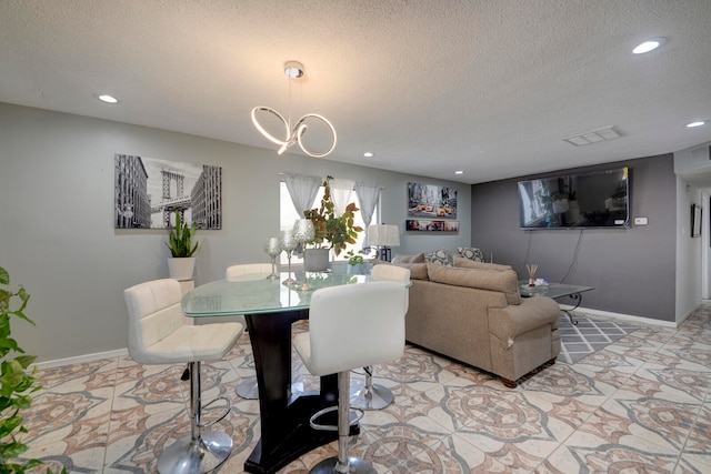 dining room with a textured ceiling