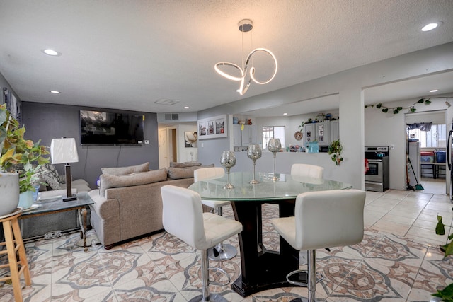 dining room with a textured ceiling and a healthy amount of sunlight