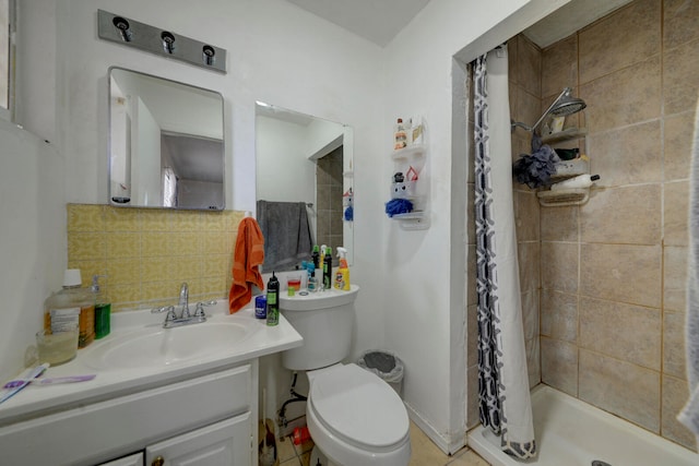 bathroom with tile patterned floors, toilet, a shower with shower curtain, vanity, and tasteful backsplash