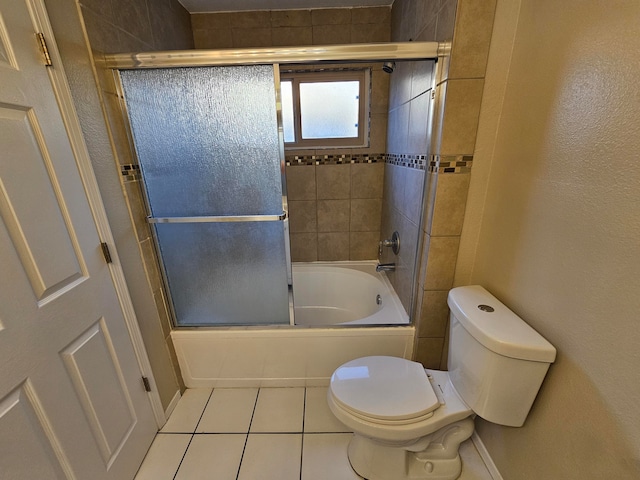 bathroom with tile patterned floors, enclosed tub / shower combo, and toilet