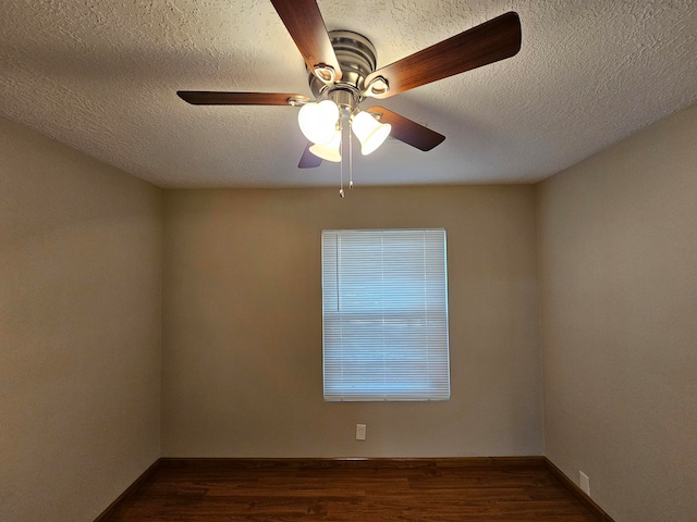 unfurnished room featuring dark wood-type flooring, a textured ceiling, and ceiling fan