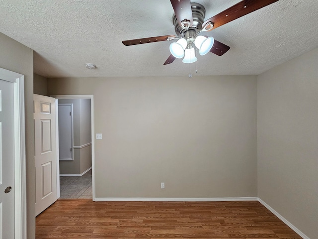 unfurnished room with hardwood / wood-style floors, a textured ceiling, and ceiling fan