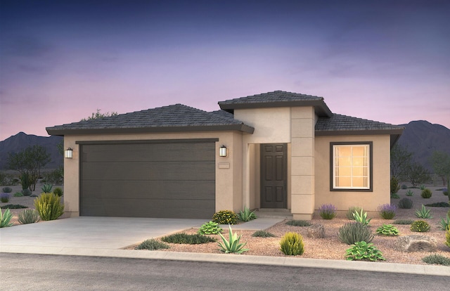 view of front facade with a mountain view and a garage