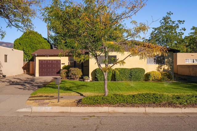 view of front of house with a front yard and a garage