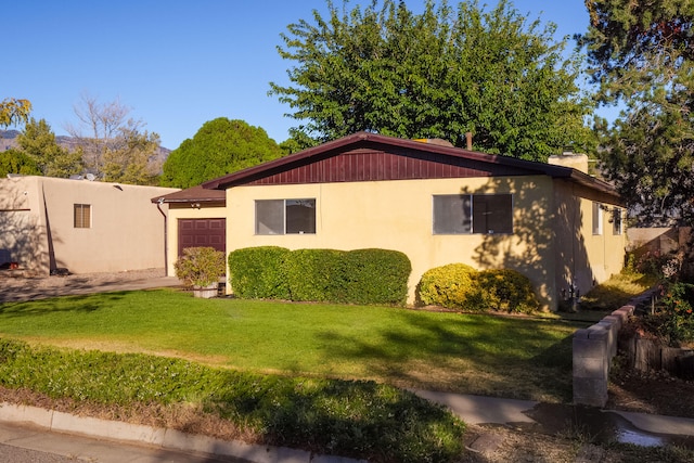 view of front of house with a front yard and a garage