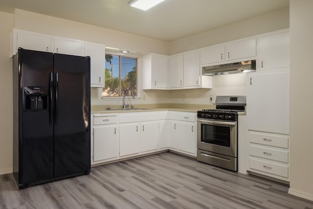 kitchen with stainless steel gas stove, black refrigerator with ice dispenser, sink, white cabinets, and light hardwood / wood-style floors