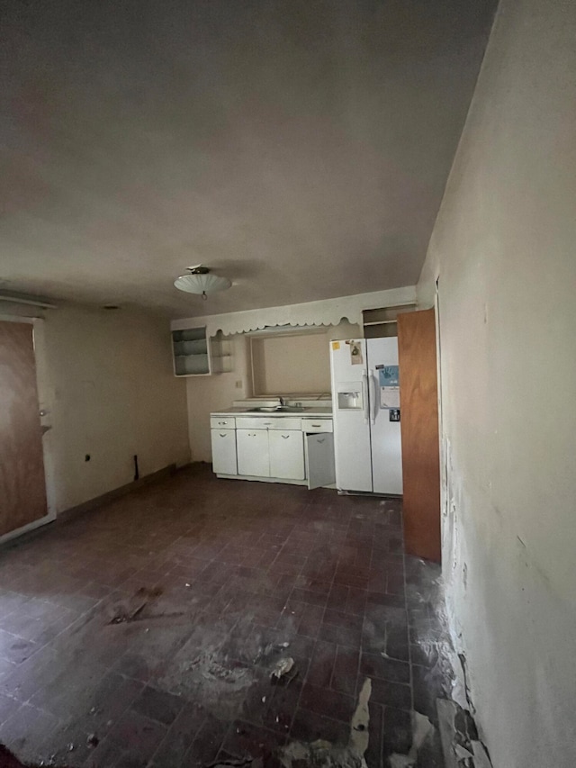 kitchen with white cabinets, white refrigerator with ice dispenser, and dark hardwood / wood-style floors