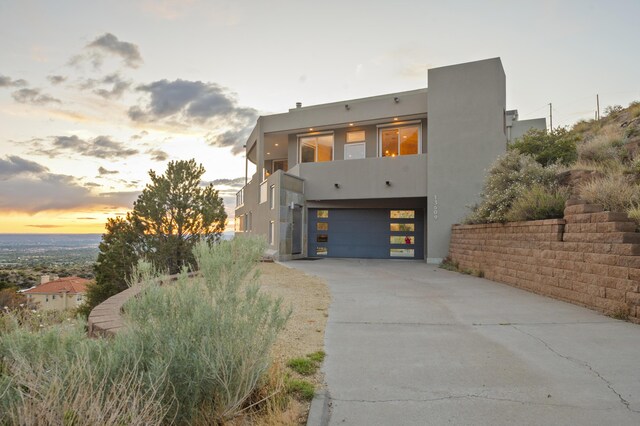 view of front of house featuring a garage and a balcony