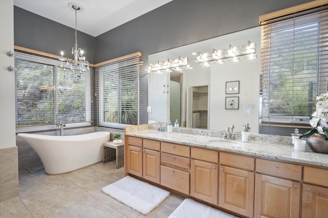 bathroom featuring a bathing tub, a wealth of natural light, vanity, and a chandelier