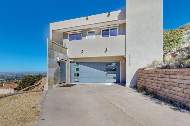 view of front of property with a balcony and a garage