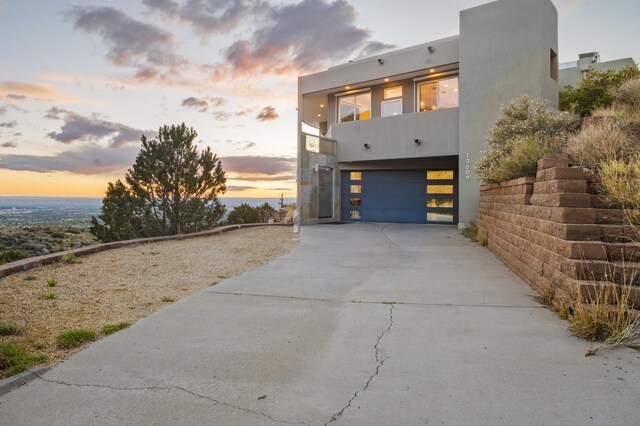 view of front of house featuring a balcony and a garage