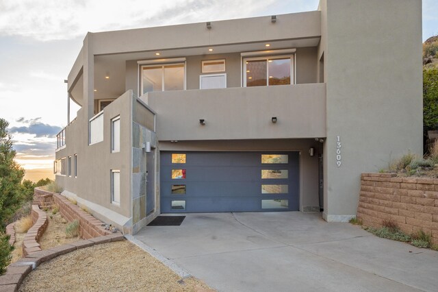 view of front of home featuring a balcony and a garage